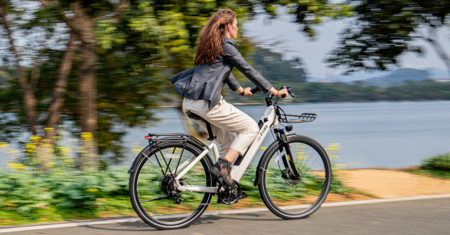 Woman riding electric bike by lake