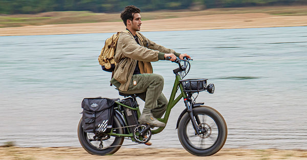 Man riding electric bike by lake