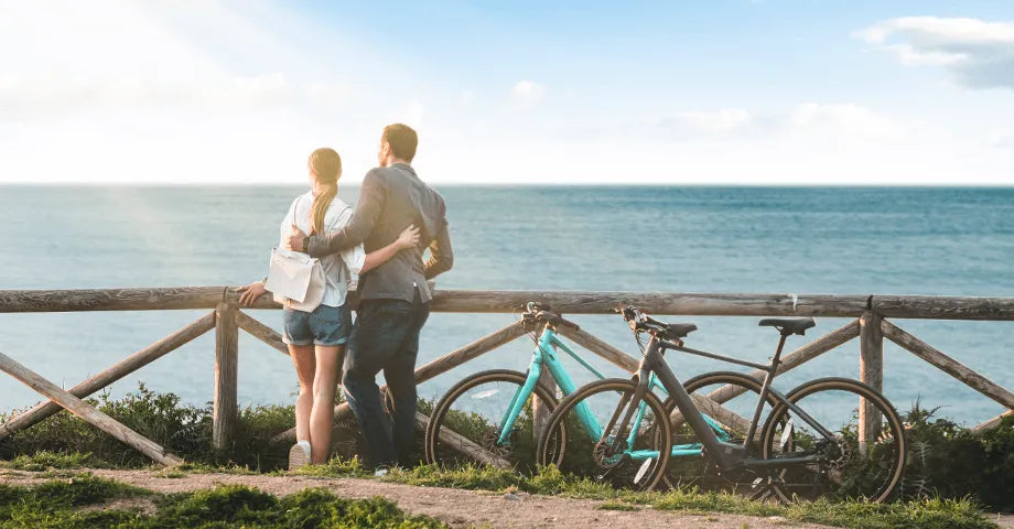 A group of couples riding Fiido C22 and Fiido C21 electric bicycles on the bridge