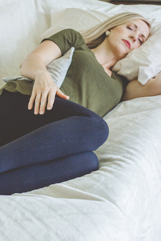 Woman lying down with heating pad