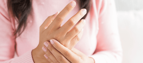 woman massaging arthritis in hand