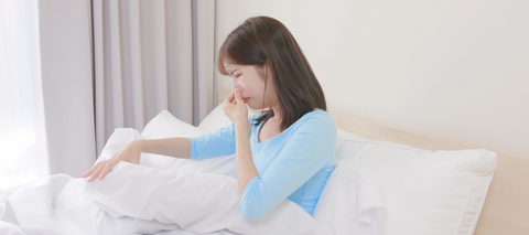 Woman holding nose from smell