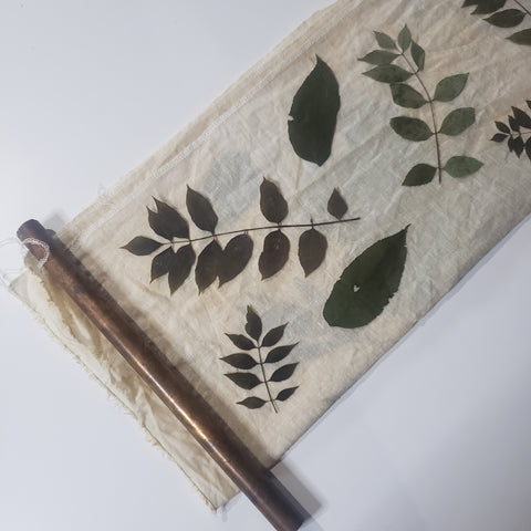 leaves on fabric with a copper pipe to bundle around
