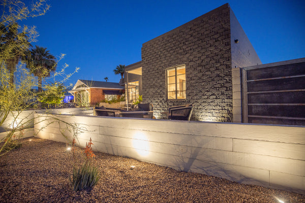 James Judge realcast board formed concrete half-wall in a courtyard