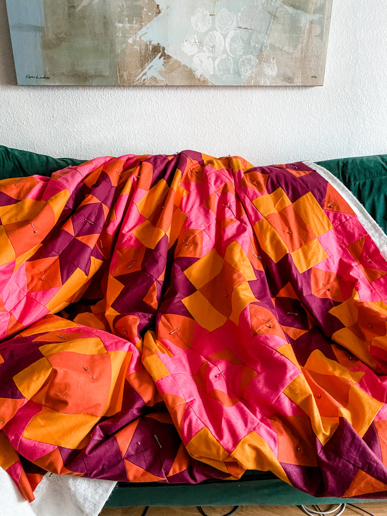 Basting a quilt on the couch