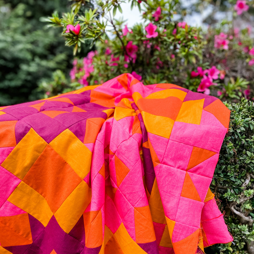 Bright pink and orange quilt with azaleas