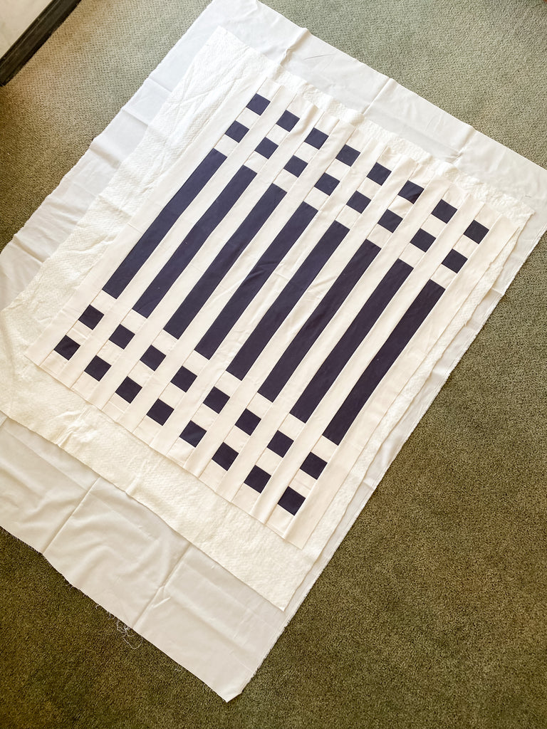 how to baste a quilt - simple stripes quilt - quilt sandwich smoothed out