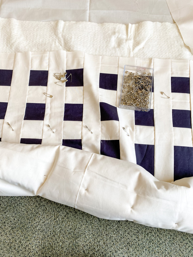 how to baste a quilt - simple stripes quilt - rolling a quilt during pin basting