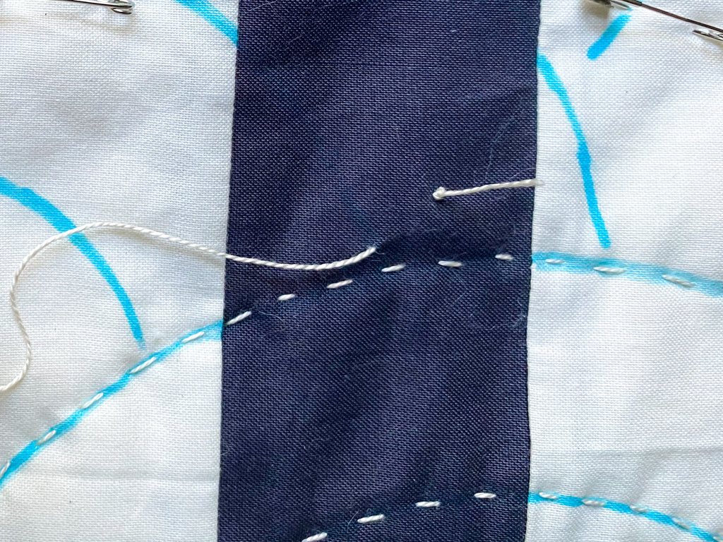 knot at start of hand quilting line