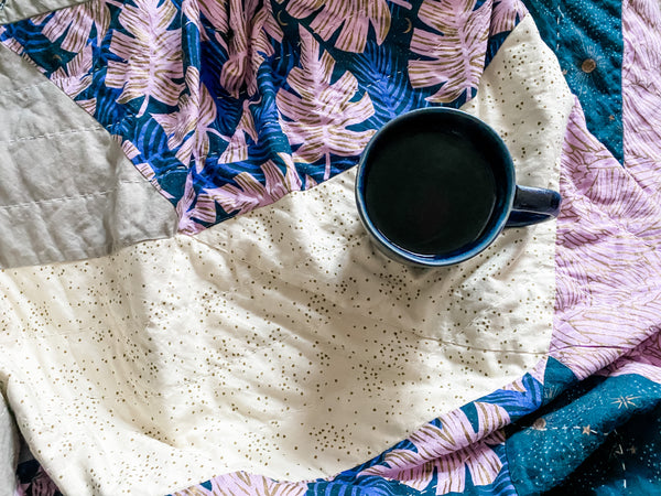 blue mug of tea on quilt