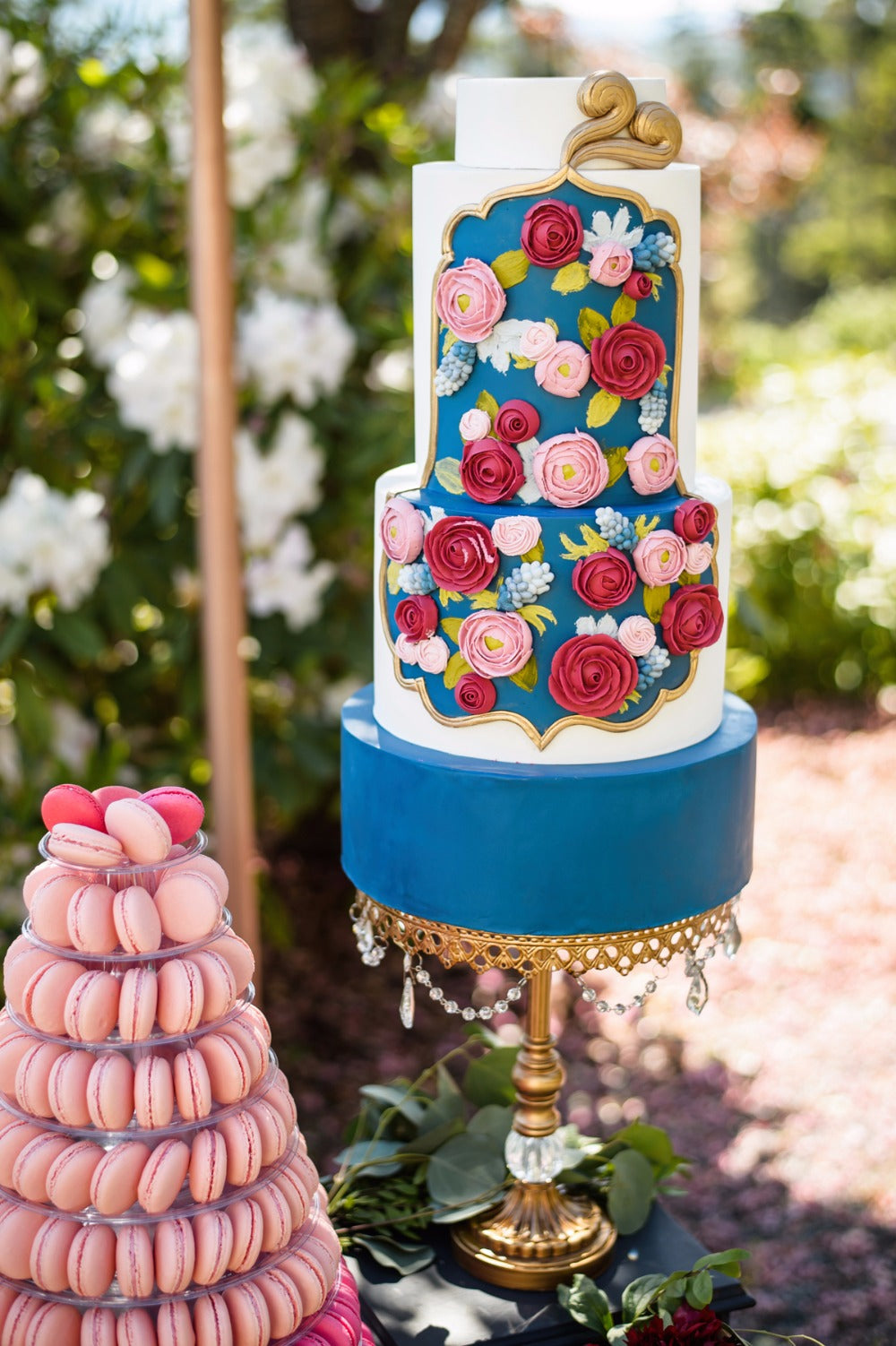 colorful tiered wedding cake on chandelier ball base cake stand