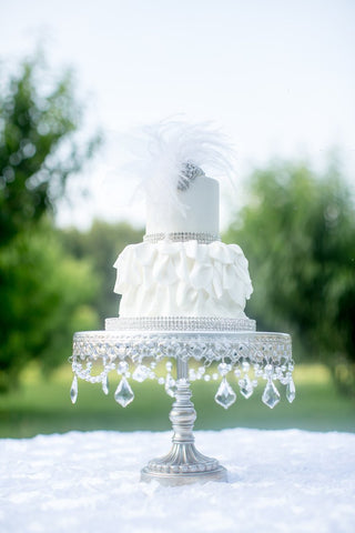 white wedding cake with feathers