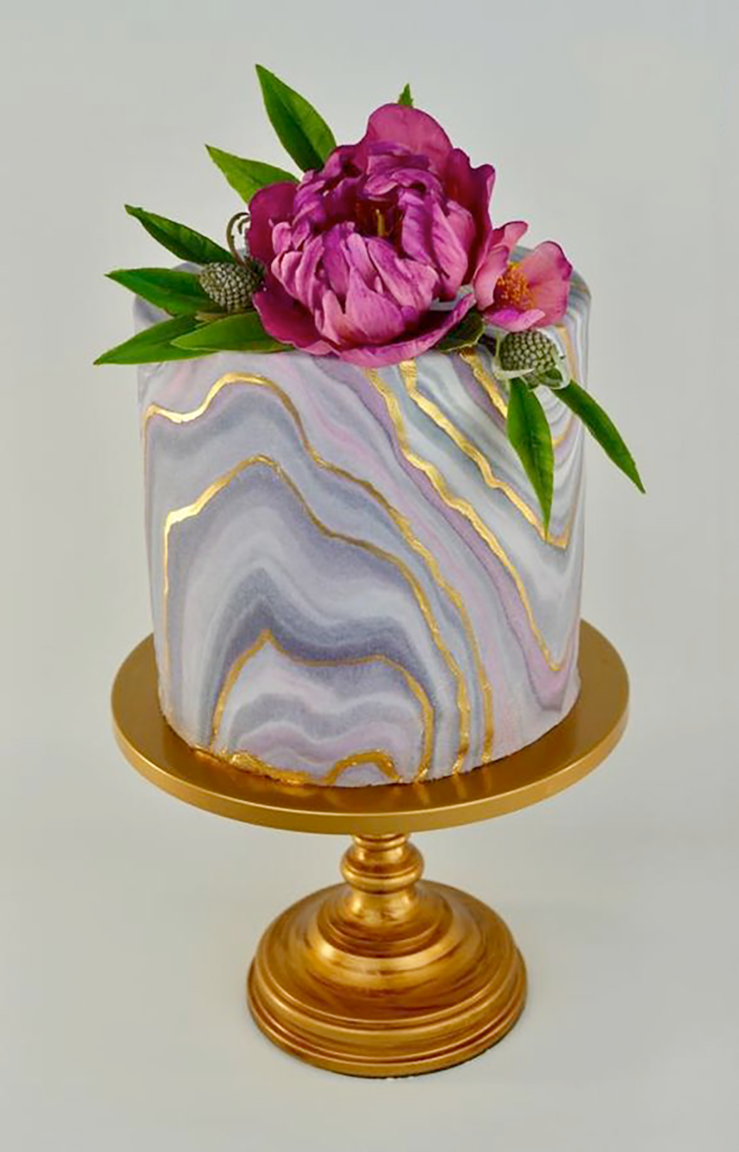 marble geode cake on simple gold cake stand