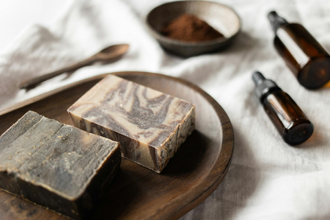 Two coffee soap bars with oils and grounded coffee.
