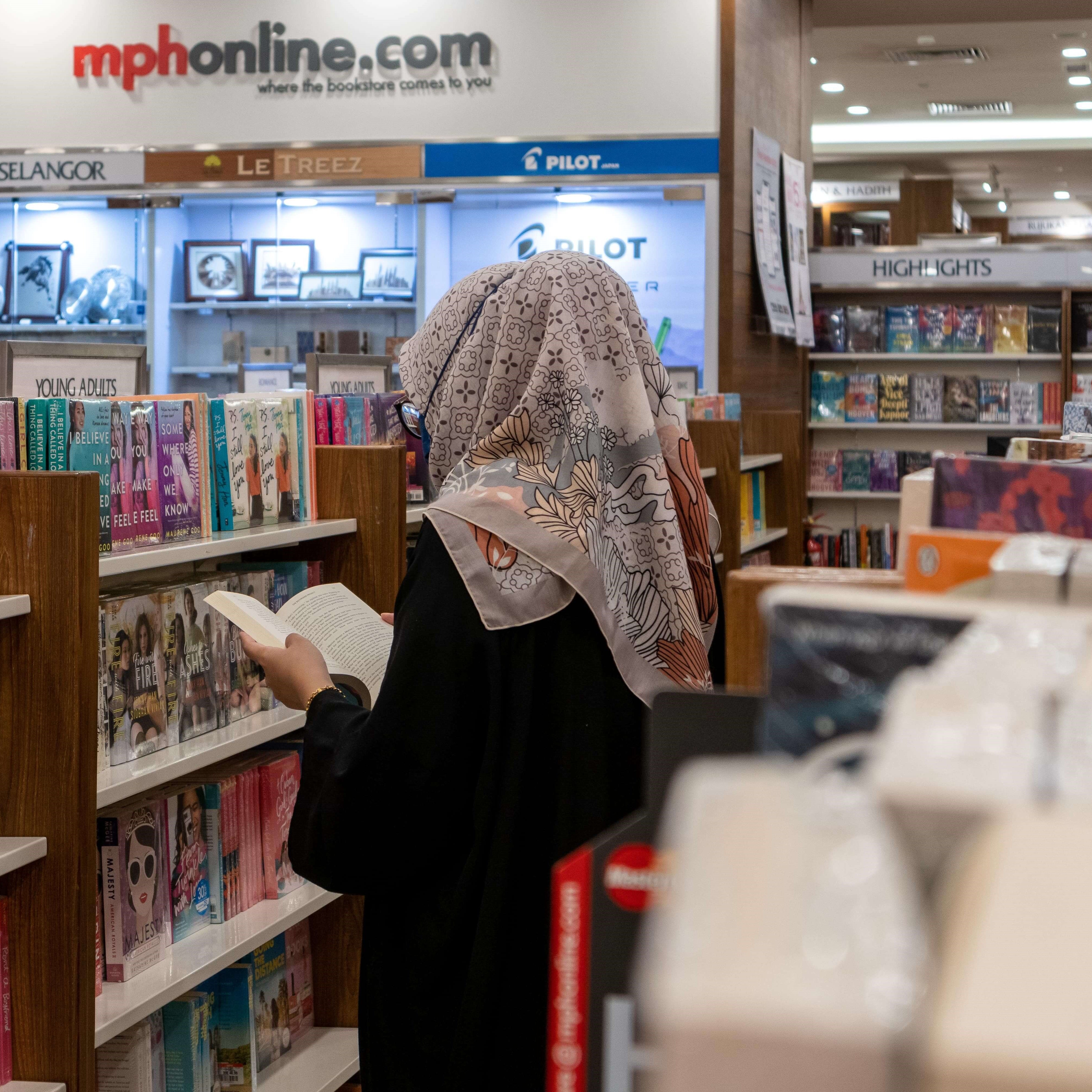 Girl reading a book at MPH Mid Valley