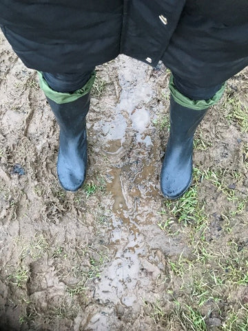 Looking down wearing new Pokeboo Tread Natural Rubber Packable Boots in a very muddy and wet path