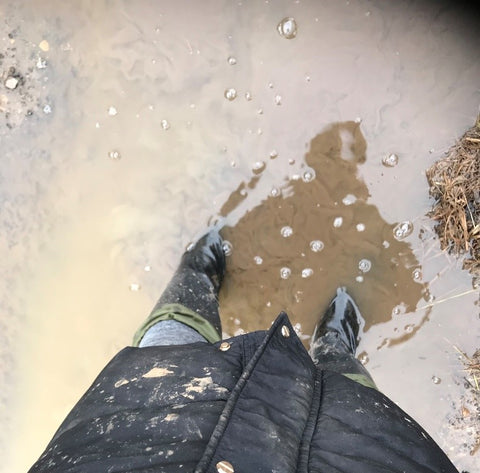 Wearing a pair of new Pokeboo Tread natural rubber packable boots in wet and muddy water