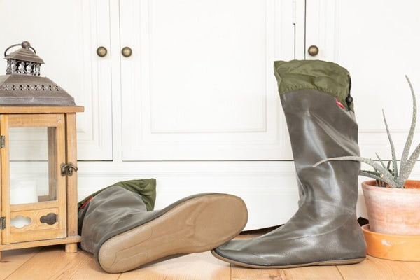 A Pair of Charcoal Pokeboo Boots with one on its side showing the flat sole of the boot