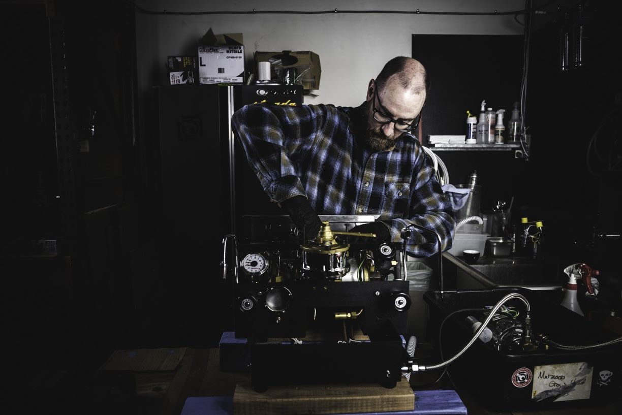 The head of our custom shop fixing an espresso machine