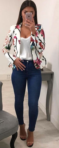 White Floral blazer with a white V-neck blouse and jeans