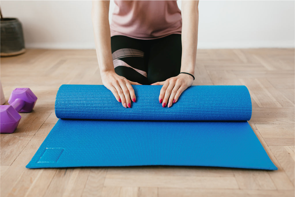 does exercising help sleep? woman rolling yoga mat