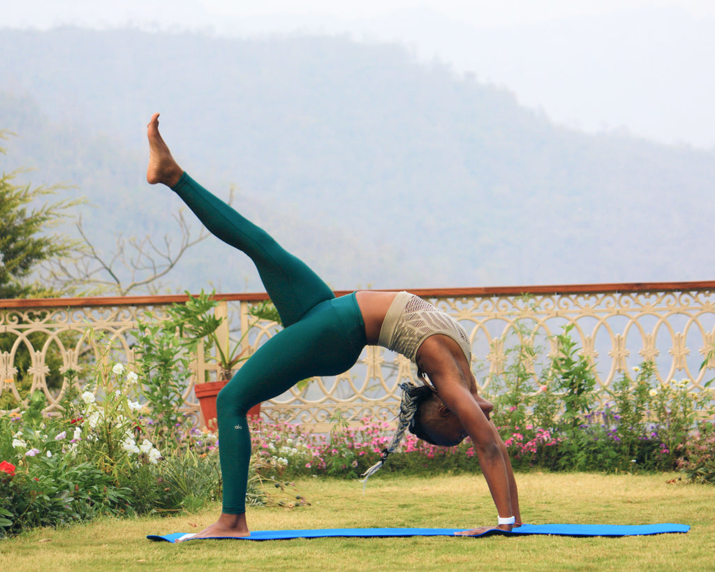 Premium Photo | A woman doing a yoga pose on a mat
