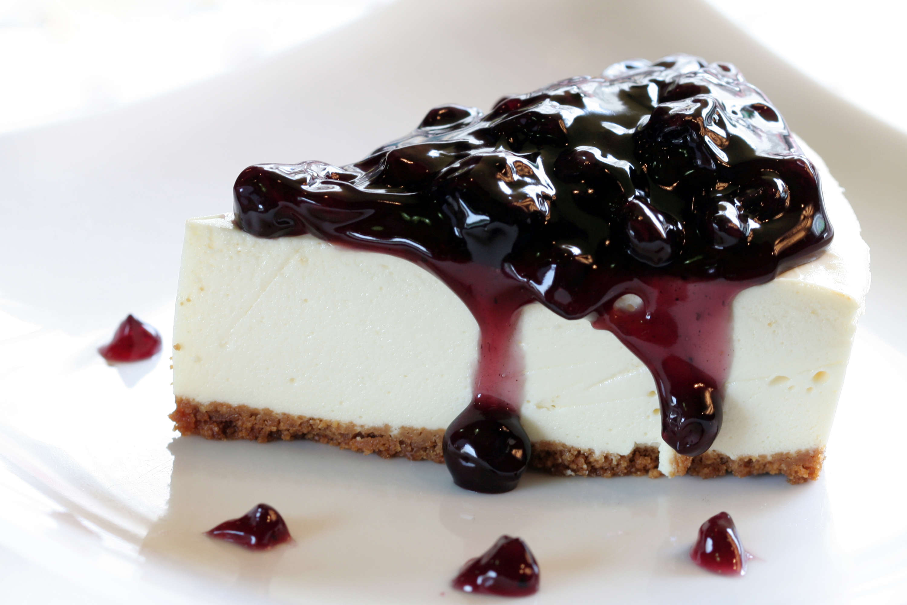 Slice of gluten-free cheesecake with blueberry topping.