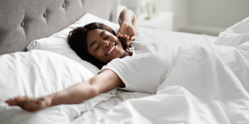 Women relaxing in bed smiling