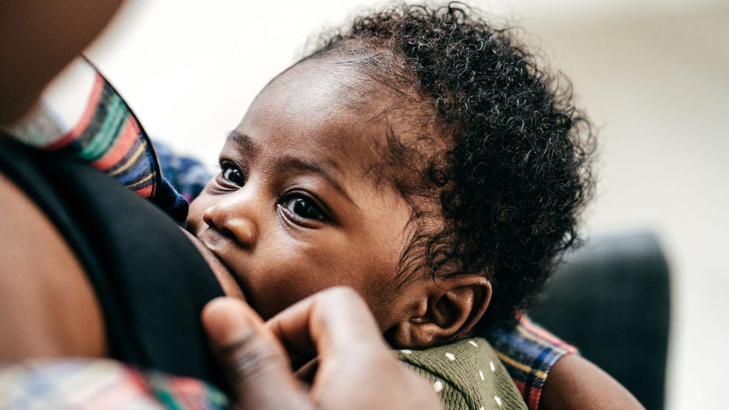 a small baby breastfeeding 