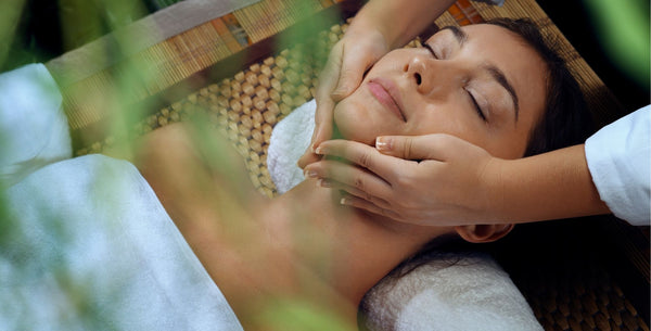 Relaxed women smiling and having face massage