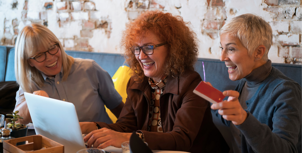 3 mature women smiling and working together