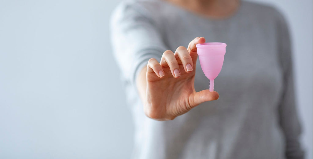 Hand holding a menstrual cup