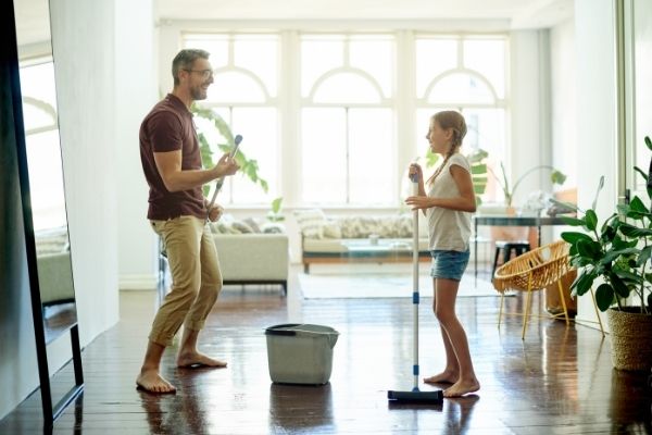 Dad and daughter spring cleaning house