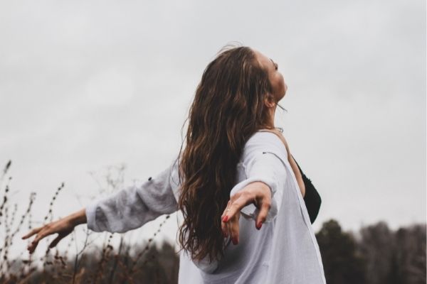 Carefree women with arms stretched back looking up