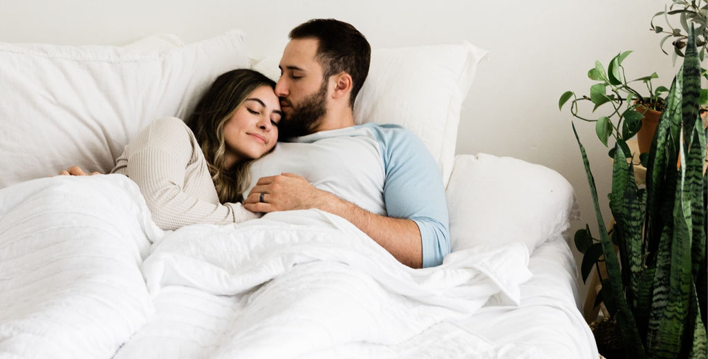 Natural couple lying in bed together