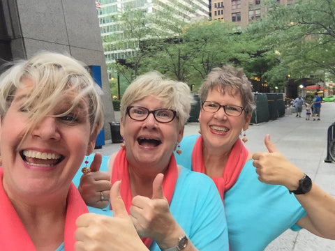 Three Duggan Sisters give thumbs up on windy Chicago street after winning Metro Chicago Export award