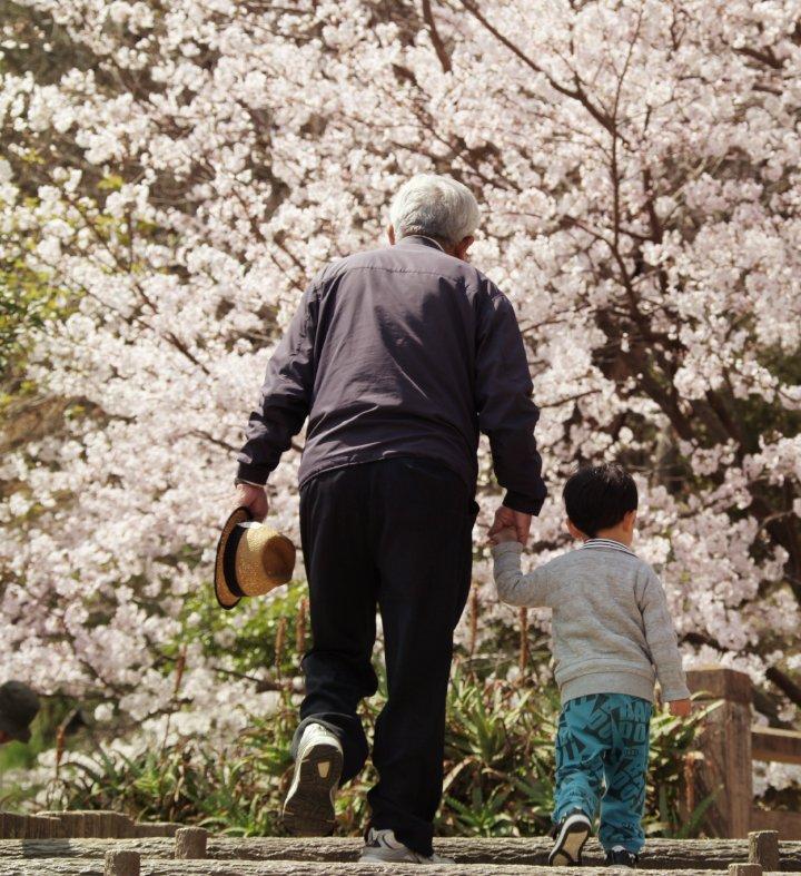 grandfather and grandson walking outside