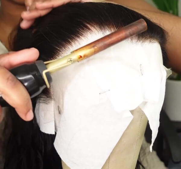 Comb back and secure your wig for plucking
