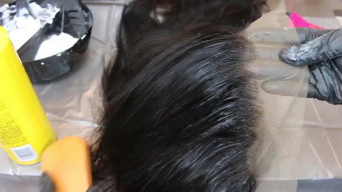brush baby hair back to prepare your wig for bleaching