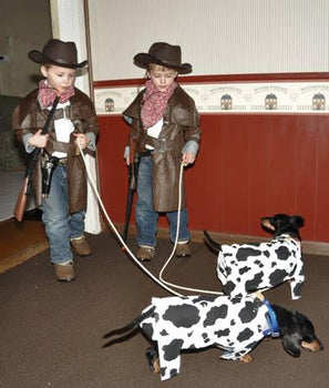 Employee, Jeanine C.'s children and dogs dressed up as cowboys and cows