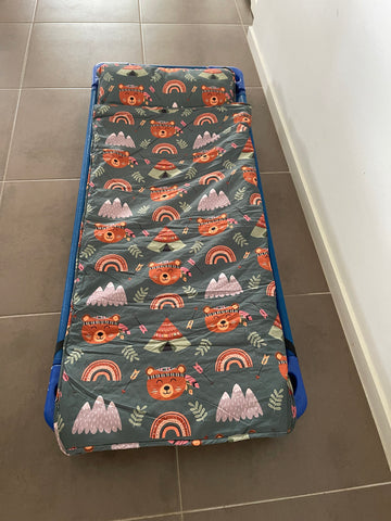 Toddler nap mats on a daycare bed