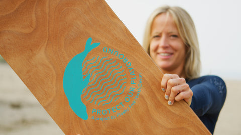 Jenny Jones holding a Plastic Free North Devon wooden belly board