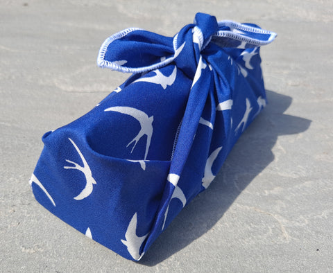 Sunglasses case wrapped in a blue furoshiki with a white swallow pattern