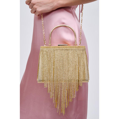 A woman holds a gold, fringed Mother’s Day purse.