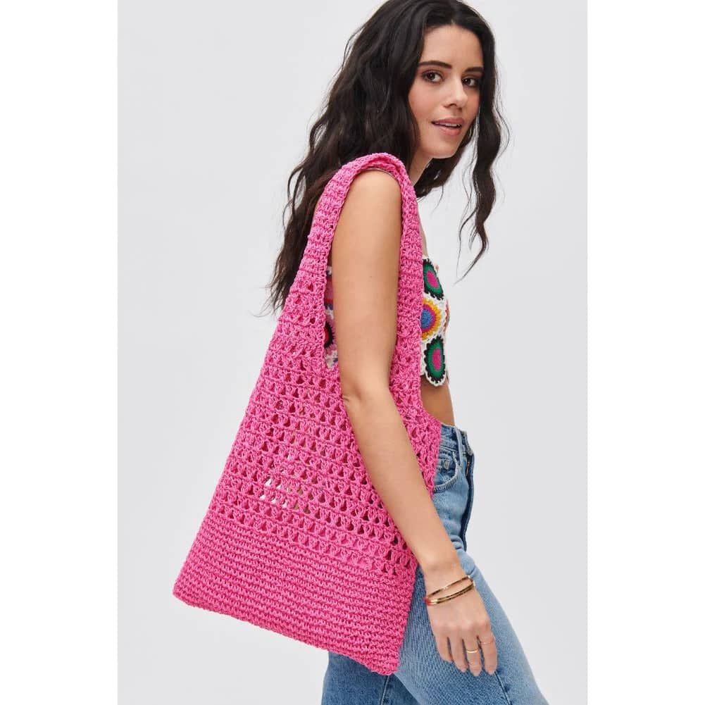 girl carrying pink vacation purse