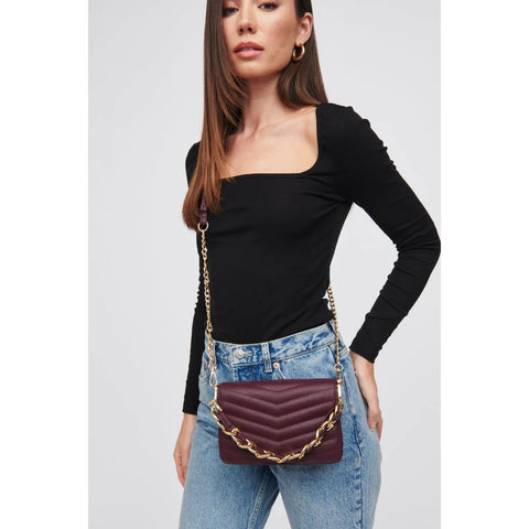 Woman in black long sleeve top and jeans wears fall handbag