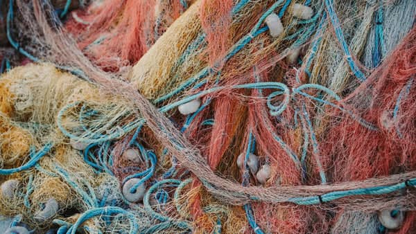 Colorful tangle of fishing nets and nylon rope destined to become recycled nylon