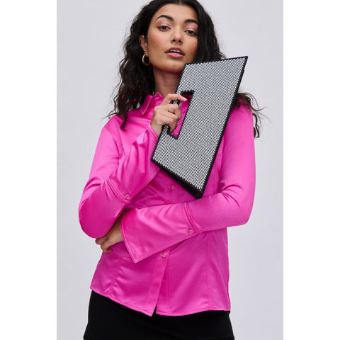 Women in fuchsia blouse holding Valentine’s Day fashion purse