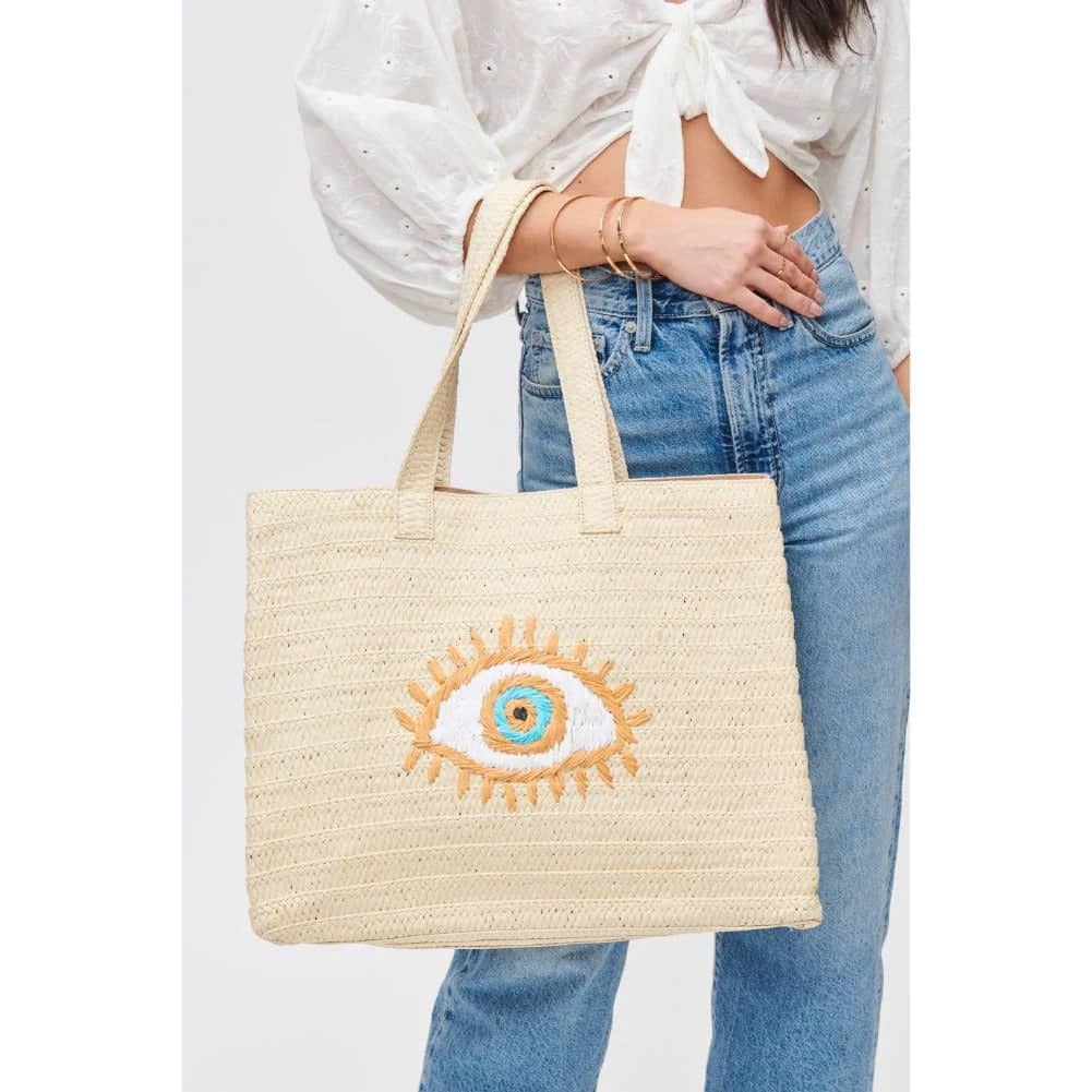 tan woven tote with evil eye