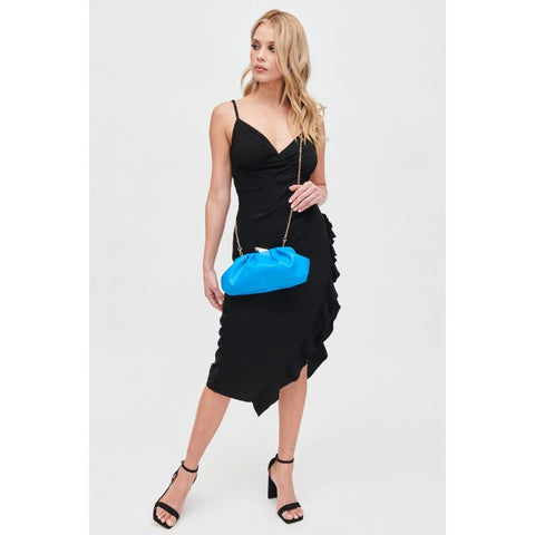 Woman in a chic black dress and heels and azure blue clutch bag with detachable strap.